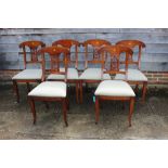 A set of six carved cherrywood standard dining chairs with pierced splat backs and stuffed over