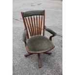 An early 20th century stained beech office armchair, on swivel base
