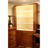 A pine corner cabinet with open shelves over two doors, on block base, 51" wide x 28" deep x 94"