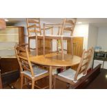 An Ercol light oak 'D' end extending dining table, 84" x 42" when fully extended, and a set of six