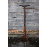 A mahogany and grained as rosewood circular topped torchere stand, on turned column and tripod splay