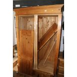 A waxed pine wardrobe enclosed two panel doors over two drawers, on block base, 48" wide x 24 1/2"