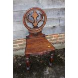 A 19th century mahogany hall chair with Gothic pierced back, on turned supports