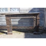 A 19th century carved oak fireplace surround with frieze panel carved figures, horses and