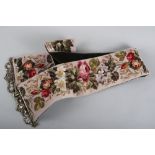 A floral tapestry bell pull and a green and white cushion with tassel decoration