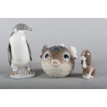 A Lladro puffer fish, "Round Fish" 1210, 3 1/2" high, a Lladro penguin, 5248, 6" high, and a