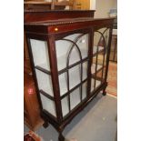 An early 20th century mahogany two door display cabinet, on ball and claw supports, 48" wide