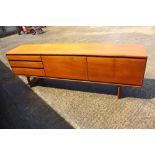 A White & Newton Ltd 1960s teak sideboard, fitted three drawers, central cocktail cabinet and