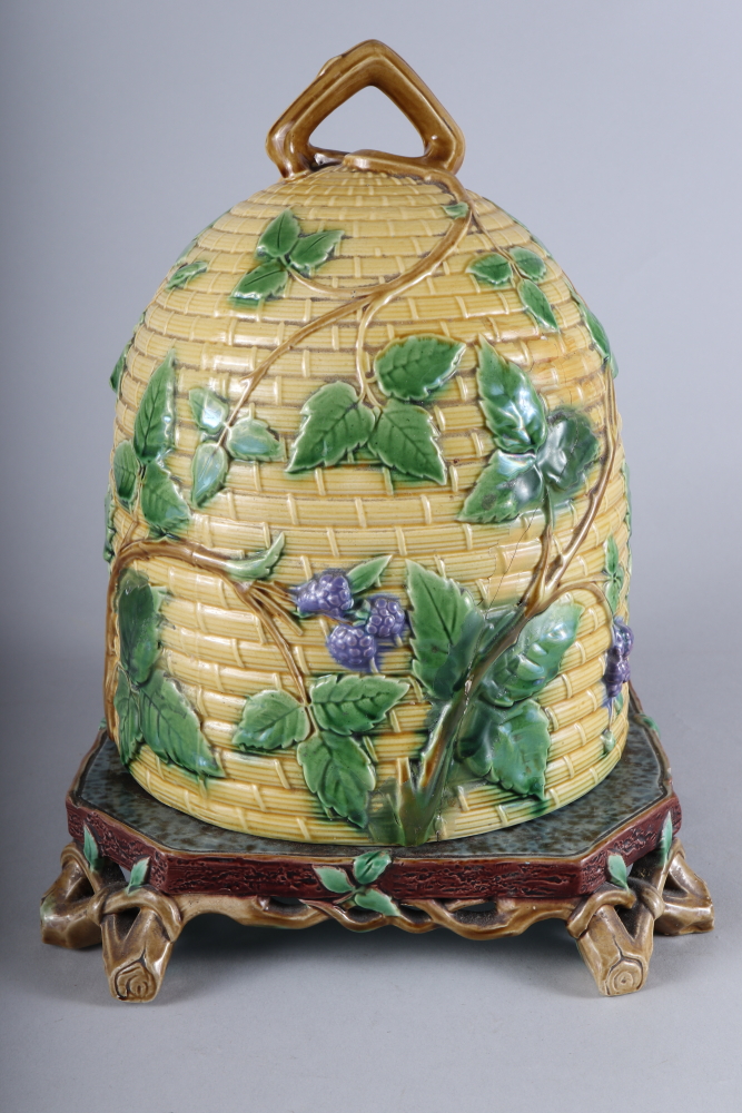 A Minton majolica cheese dish, in the form of a bee skep, 14" high (chip to base, cover restored)