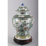 A Chinese porcelain inverted baluster vase and cover, decorated in famille verte enamels