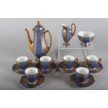 A Royal Doulton coffee set with octagonal baluster bodies, decorated powdered blue and gilt