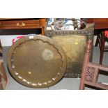 An anodised brass fire screen, a white painted saucepan stand and a Middle Eastern engraved brass