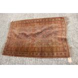 A tribal rug with geometric tree design in shades of brown, 52" x 34" approx