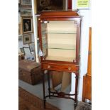 An Edwardian mahogany gallery top display cabinet enclosed single glazed door over one drawer, on