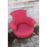 A Victorian tub-shaped armchair, upholstered in a scarlet moquette, on turned and castored supports