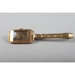An early 20th century 9ct gold cased Rolex with rectangular dial and baton numerals