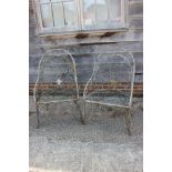 A pair of Art Nouveau design wrought metal tub-shape garden armchairs, on scroll supports