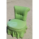 A late 19th century low seat nursing chair, button upholstered in a green linen