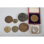 A group of medallions, including a cased Edward VII Coronation medal, a Holborn restaurant