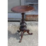 A 19th century oak circular top occasional table, on turned and carved column and tripod supports,