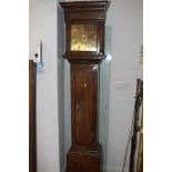 An early 18th century oak long case clock with single hand engraved brass dial and thirty-hour