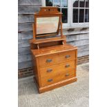 A satin walnut dressing chest, fitted mirror over three long drawers, on block base, 36" wide x