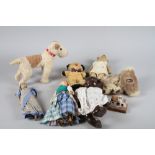 A vintage teddy bear, a toy terrier, a koala bear, an Indian doll and other toys