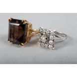 A white metal and diamond dress ring, size M, and a yellow metal and smoky quartz dress ring, size