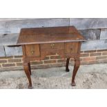 A late 17th century/early 18th century oak lowboy, fitted three drawers over shaped kneehole, on