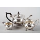 A silver three-piece teaset with ebonised handle and knop, 37.2oz troy approx