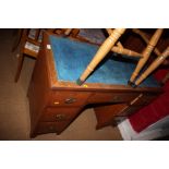 A burr maple double pedestal desk with blue tooled lined top over seven drawers, on bracket feet,
