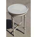 A white and gilt painted circular top occasional table, on reeded supports