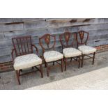 Three mahogany and string inlaid shield back side chairs, upholstered in a cream brocade, on