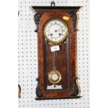 A mahogany and ebonised cased mantel clock with scrolled decoration, white enamelled dial and