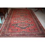 A Royal Keshan carpet of traditional Persian design with four medallions on a red ground, 120" x 78"