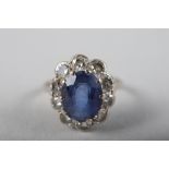 An 18ct gold, platinum, diamond and sapphire cluster ring, size M/N, 3.2g