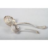A 19th century silver sifter spoon with embossed engraved decoration and a smaller similar, 2.7oz