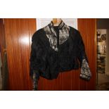 A Victorian evening dress and jacket with netted and frilled sleeves and black brocade