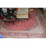 A mid 20th century Persian carpet with all-over floral design on a red ground and multi-bordered