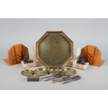 An Indian engraved brass octagonal tray and smaller similar pin trays, three nut cracks, a Bell & Co