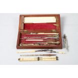 A set of late 19th century drawing instruments with ivory rules and handles, in fitted case