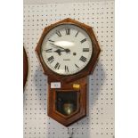 A mahogany octagonal cased drop dial clock with white enamel dial and Roman numerals by K Norman,