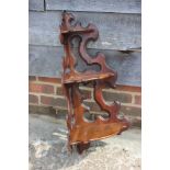 A Victorian carved walnut corner hanging three-tier whatnot/wall shelf with bowfront shelves, 15"