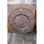 A circular embossed copper plaque, traces of gilding, centre with Battle of Anghiari after Leonardo,