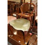 A mahogany loop back occasional chair, upholstered in a green velour, on cabriole supports, a 17th
