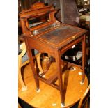 A lady's mahogany and inlaid writing desk with raised shaped mirror back, on square tapered castored