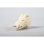 A carved ivory wild boar's head, 2 1/4" long overall