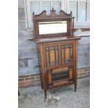 An Edwardian rosewood and inlaid music cabinet with mirror panel back over panelled door, 30" wide x