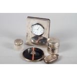 A silver double sovereign case, a travelling inkwell, a silver cased clock, 4 1/2" high, a compact
