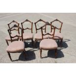 A set of six late Victorian carved walnut bar back side chairs, upholstered in a fish scale ground